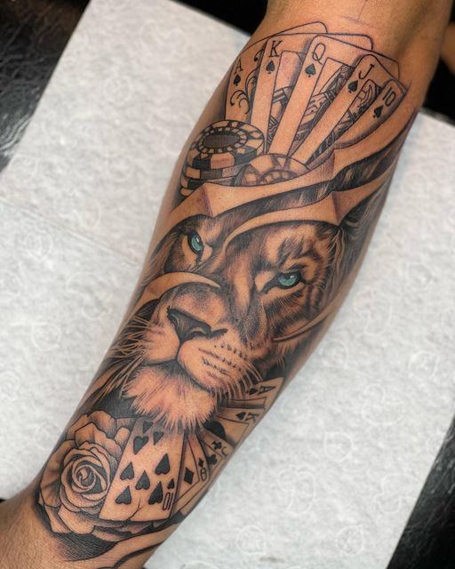 Lion with playing cards and poker chips sleeve tattoo