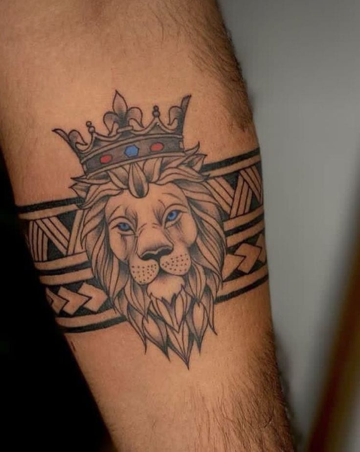 Lion with crown in a tribal armband tattoo